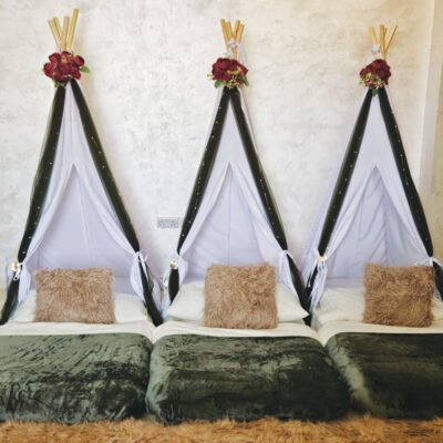 rose garden themed teepee sleepover setup in Dubai luxury girls teepee party with merlot flowers and fairy lights totally teepee rose garden sleepover in Sharjah UAE floral teepee tents for girls birthday sleepover in Ras Al Khaimah cozy indoor sleepover setup with faux flowers and LED lights UAE